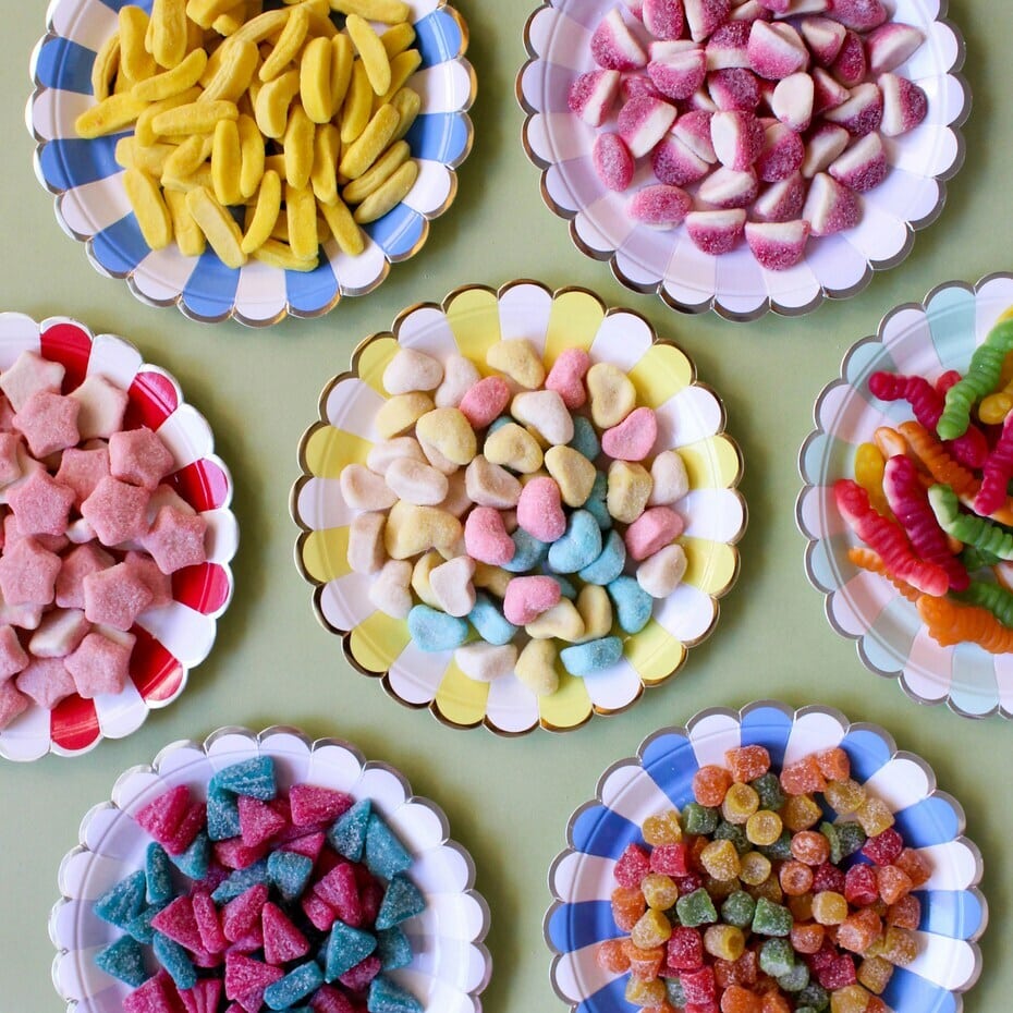 colourful vegan sweets on plates – best vegan sweets in the UK