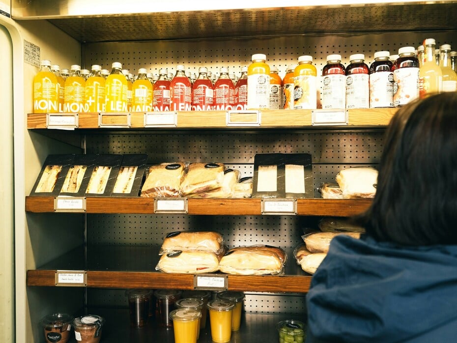 Chiller shelf with pre-packed sandwiches, drinks, and snacks in a UK-style meal deal display