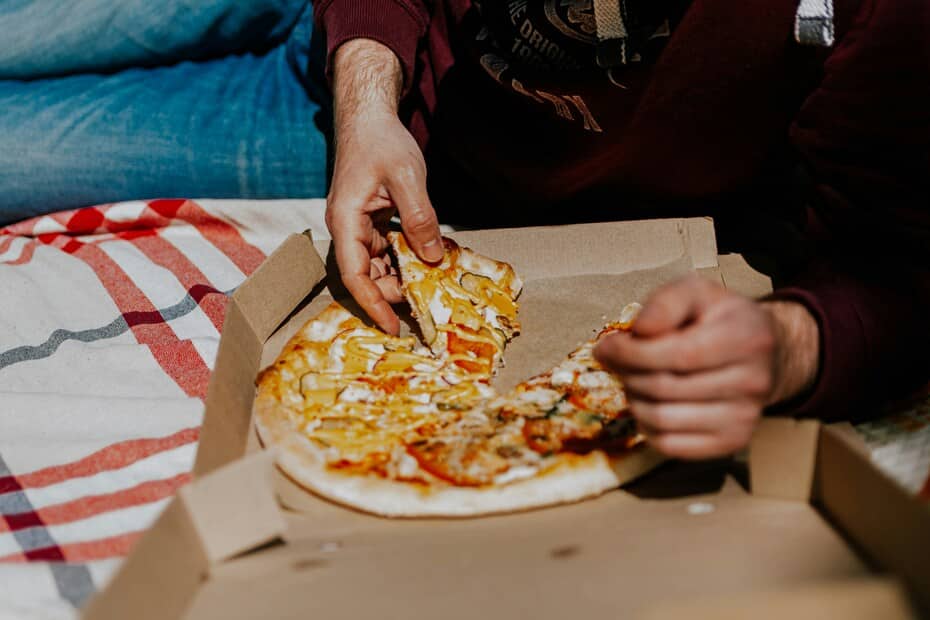 Vegan pizza takeaway with melted cheese and mustard drizzle – best vegan takeaway in the UK